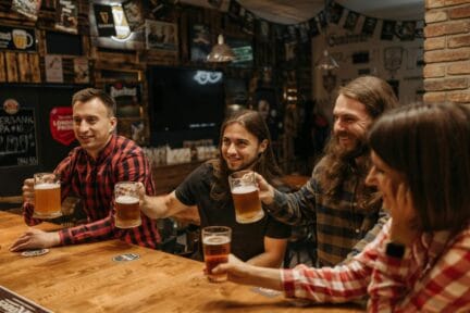 Men drinking pints of beer at a table